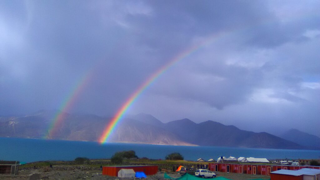 Pangong Lake with double rainbow . View Captured by travelhikes